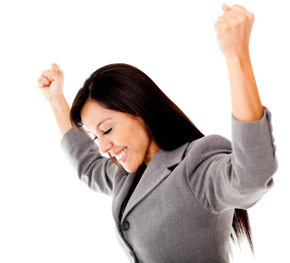 Successful businesswoman with arms up - isolated over a white background